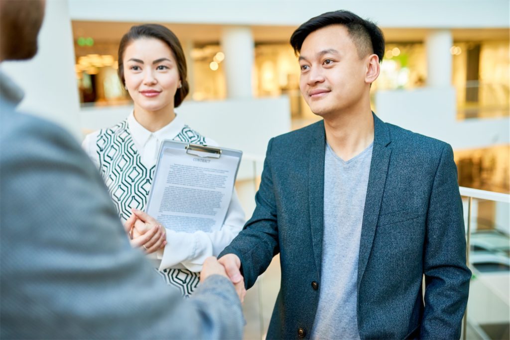 A man shaking hands with another man