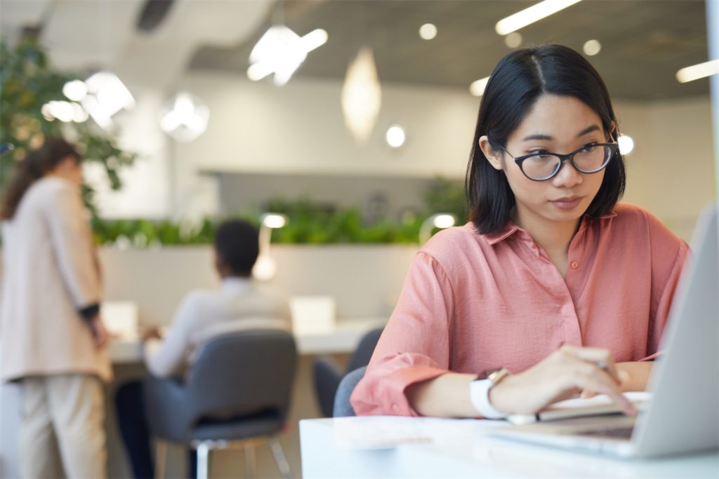 A woman looking at her laptop