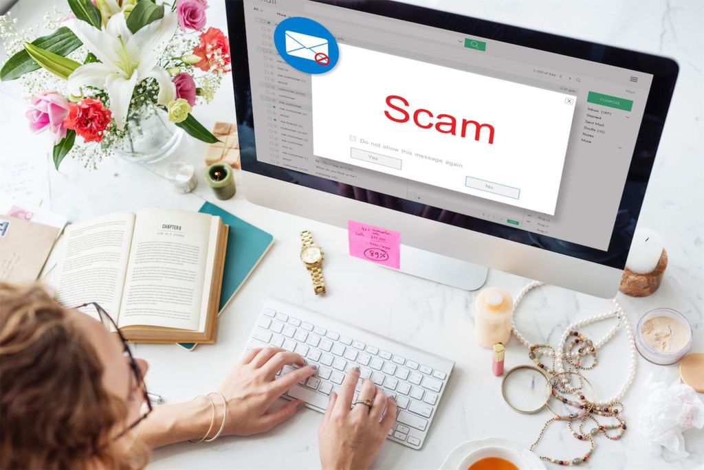 Woman on computer with a scam popup