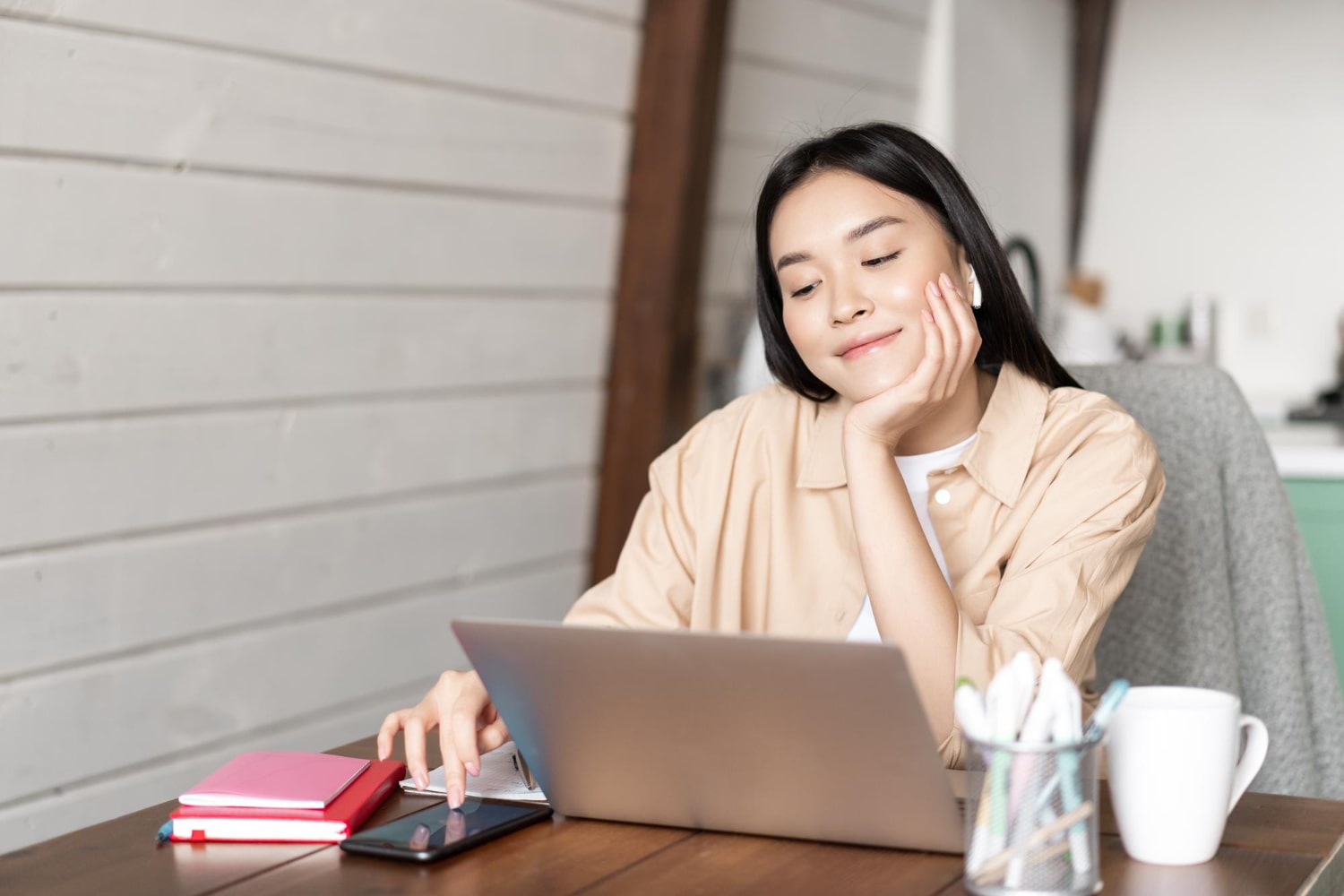 Woman working on laptop at home desk