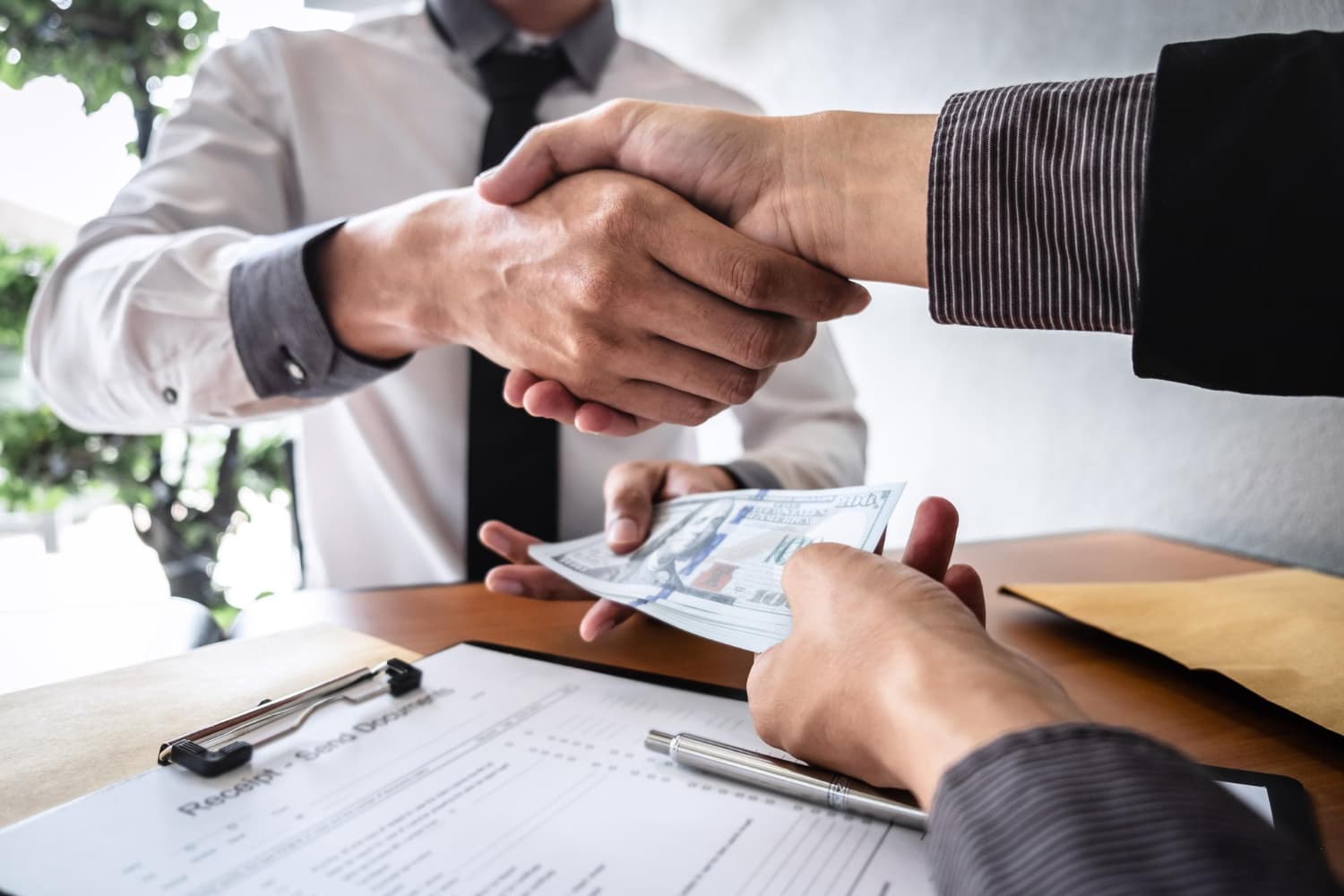 Borrower receiving cash loan from licensed moneylender in Singapore after signing credit agreement