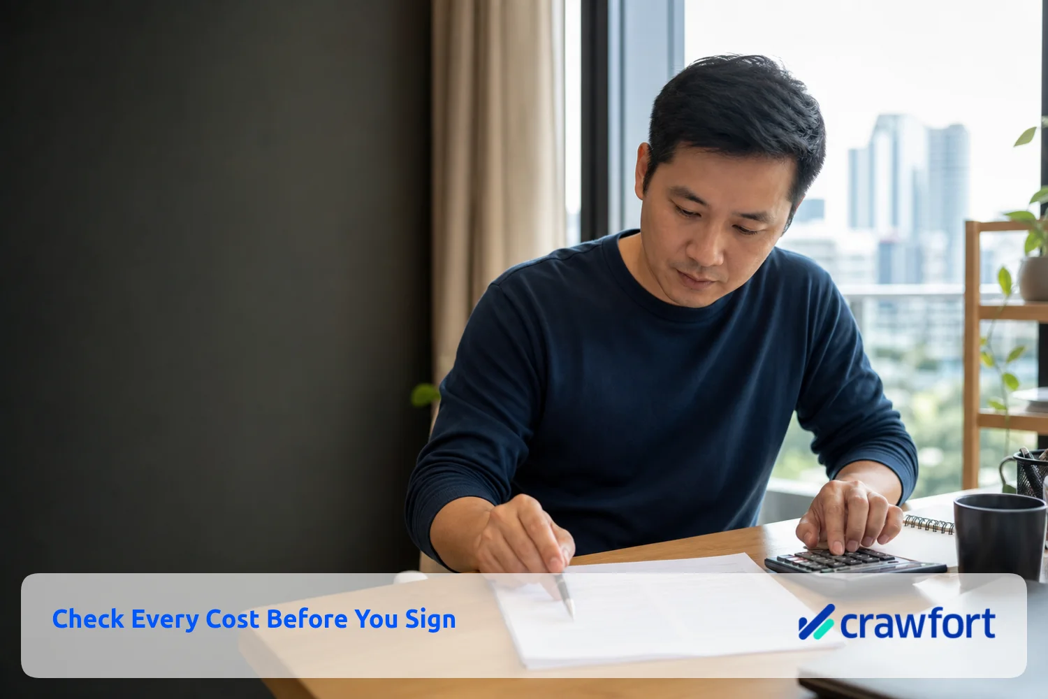 Borrower reviewing a loan contract and checking the figures on a calculator