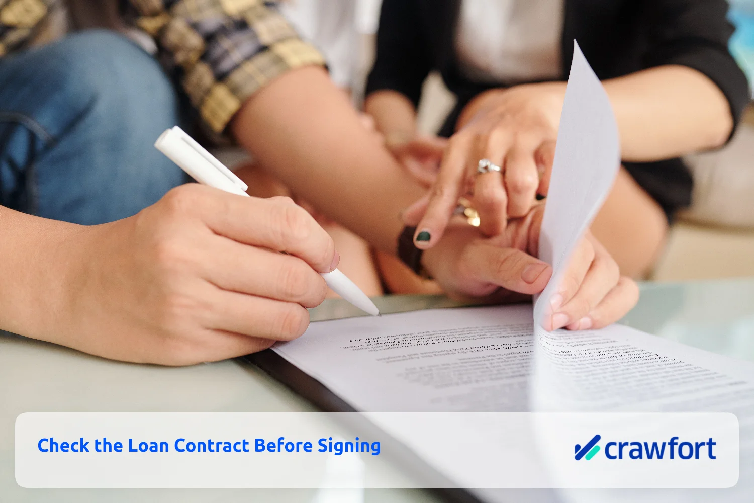Borrower reviewing and signing a loan contract after checking the terms