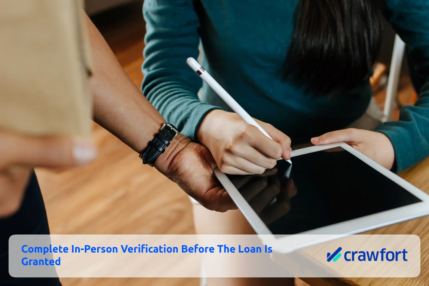 Borrower reviewing and signing loan documents in person on a tablet