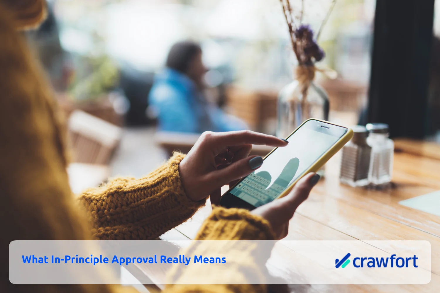 Person using a mobile phone to review the meaning of in-principle loan approval